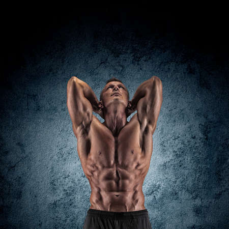 Sexy muscular guy in the studio shows the various movementsの写真素材