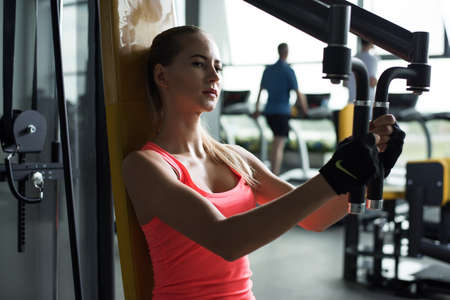 Athletic young woman resting during exercise in the gymの写真素材