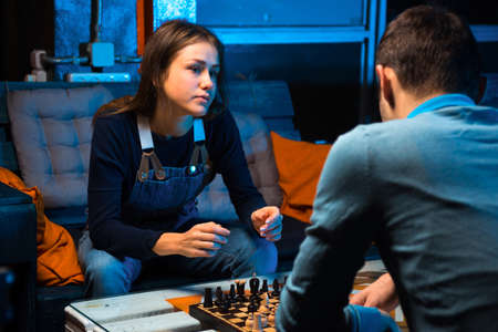 Young people playing chess in the games roomの写真素材