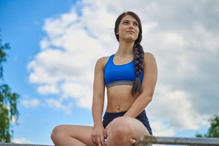 A young girl in a T-shirt and shorts goes in for sports outdoorsの写真素材