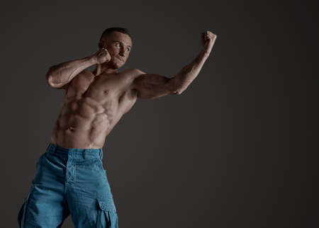 Adult male fighter MMA. In a studio.