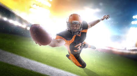 American football player at the stadium in black and orange outfit.の写真素材
