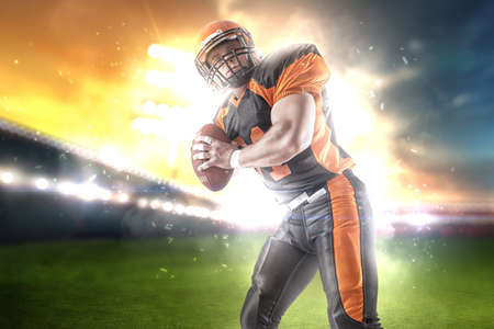 American football player at the stadium in black and orange outfit.