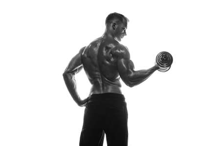 Fitness model Man posing in the studio. White background. Isolated.の写真素材