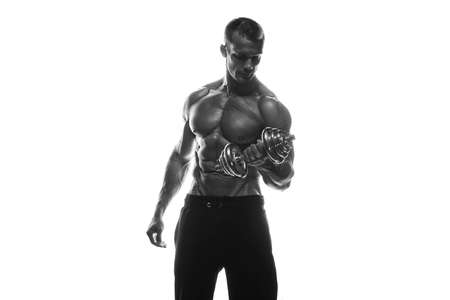 Fitness model Man posing in the studio. White background. Isolated.の写真素材