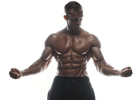 Fitness model Man posing in the studio. White background. Isolated.の写真素材