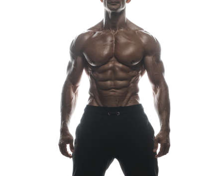 Fitness model Man posing in the studio. White background. Isolated.の写真素材