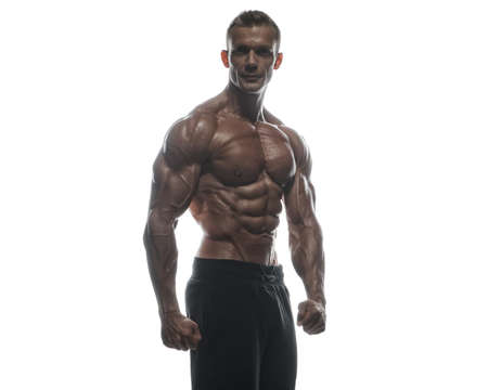 Fitness model Man posing in the studio. White background. Isolated.の写真素材