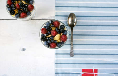 Light summer dessert for breakfast or a snack: cereal, oatmeal, fruit, yogurt.の写真素材