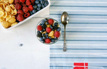 Light summer dessert for breakfast or a snack: cereal, oatmeal, fruit, yogurt.の写真素材