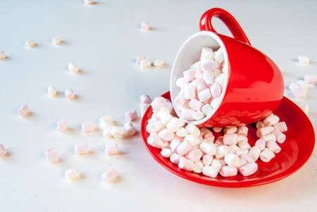 Concept: Christmas mood. Mug filled with marshmallow on a light background.の写真素材