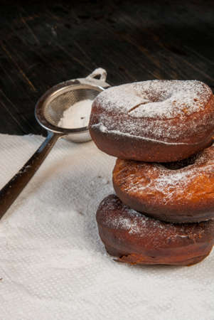 Fresh homemade donuts sprinkled with powdered sugar, top view, copy spaceの写真素材