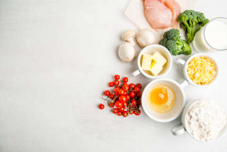 The selection of ingredients for the preparation of traditional French dishes quiche lorraine, on white wooden table, top view, copy spaceの写真素材