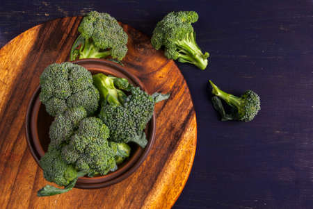 Fresh raw broccoli on a wooden table, top view, copy spaceの写真素材