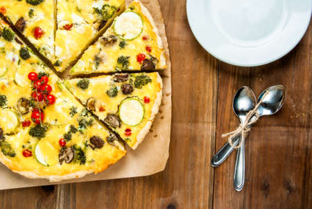 Freshly baked homemade pie quiche lorraine on a wooden tableの写真素材