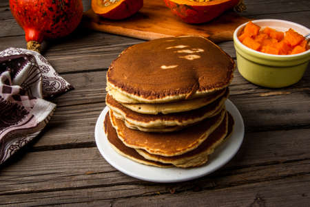 Homemade pancakes with pumpkin jam. Rustic style, on a wooden tableの写真素材