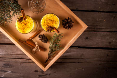 Traditional Christmas drink eggnog and cookies on a wooden backgroundの写真素材