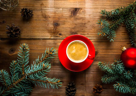 Christmas breakfast, fragrant coffee next to the Christmas tree branches, pine cones and decorations, top view, copy spaceの写真素材