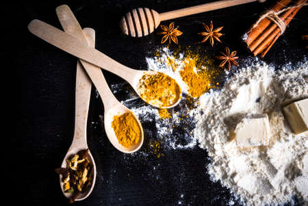 Ingredients for ginger biscuits, Christmas baking, and baking to the day of Thanksgiving: ginger, cinnamon, cardamom, citrus peel, anise. Top view, copy spaceの写真素材