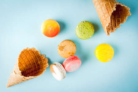 Multicolored macaroon cookies with ice cream conesの写真素材