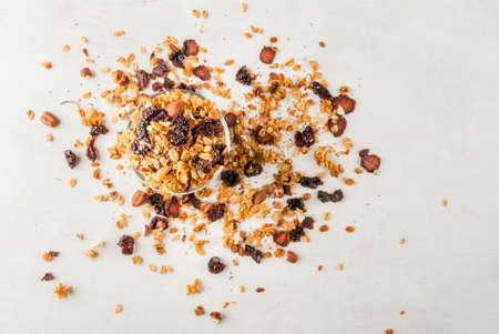 Homemade granola with dried fruits and nuts. Top view On white tableの写真素材