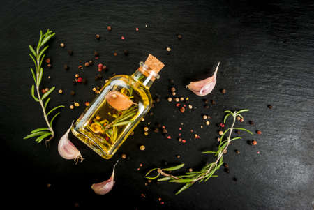 Selection of spices for cooking dinner - garlic, onions, red, black and white pepper, rosemary,...