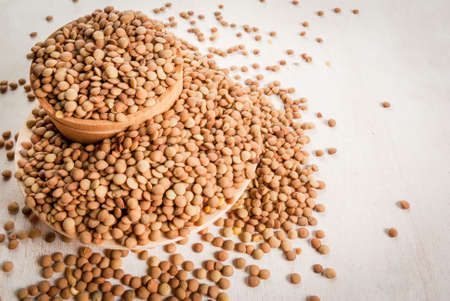 Lentils in bowls on a white wooden table, copy spaceの写真素材