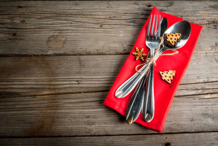 Wooden rustic table with cutlery and christmas decorations, Top view, copy space.の写真素材