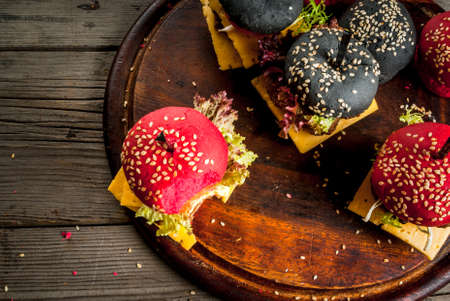 Micro burgers on a rustic wooden table, one-bite snack, top view, copy spaceの写真素材