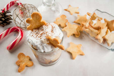 Christmas dessert, funny food for children or party. Ginger Trifle with gingerbread in form of men, diving in the drifts of whipped cream.の写真素材