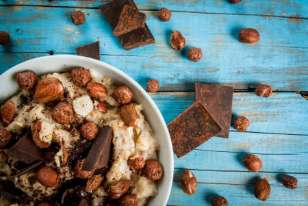 Nourishing and delicious breakfast, oatmeal with hazelnuts, dark chocolate and a chocolate corn...