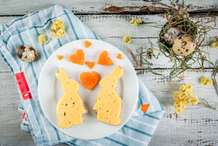 Cute and funny breakfast for Valentine's Day or  Easter: sandwiches in the form of bunnies, hearts supplemented carrot and quail eggs.の写真素材