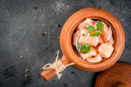 Ready for roasting raw chicken in the village clay pan, on  cutting stone table, top view, copy spaceの写真素材