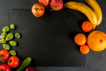 Table and a cutting board with food for a healthy diet - fruits and vegetables, top view, copy spaceの写真素材