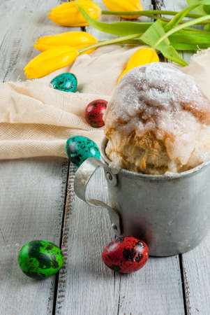 Spring Holiday Easter: Easter cake in a rustic metal mug, decorated with icing and powdered sugar,...