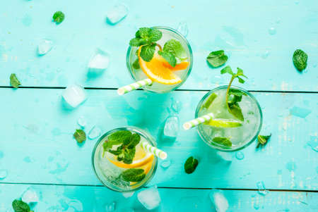 Selection of summer refreshing cocktails with mint (lemonade or mojito): with lemon, orange, lime....