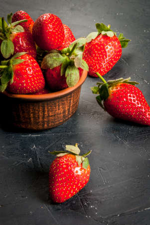 Fresh raw organic homemade strawberry on a dark gray concrete (stone table),copy spaceの写真素材