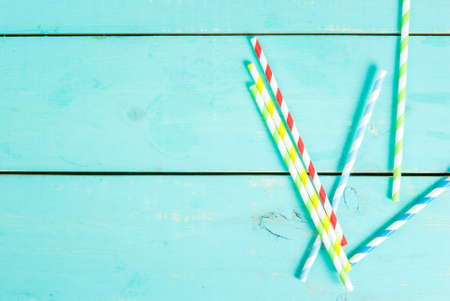 Summer blue wooden table with straws. Preparing for the party, vacation, top view, copy spaceの写真素材