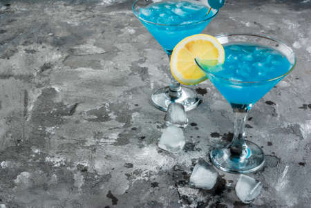 Party, cocktails blue lagoon or blue curacao on a concrete stone table, copy spaceの写真素材