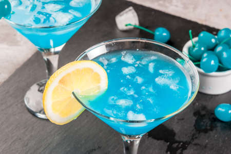 Party, cocktails blue lagoon or blue curacao on a slate tray on concrete stone tableの写真素材