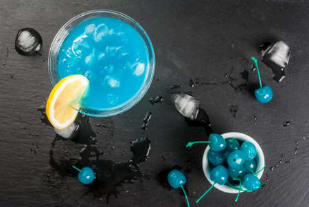 Party, cocktails blue lagoon or blue curacao on a slate tray on concrete stone table top view copy spaceの写真素材