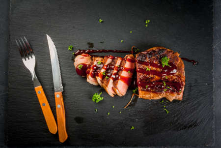 Fresh homemade fried beef steak with barbecue sauce and herbs, top view copy spaceの写真素材