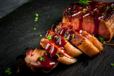 Fresh homemade fried beef steak with barbecue sauce and herbs, close view copy spaceの写真素材