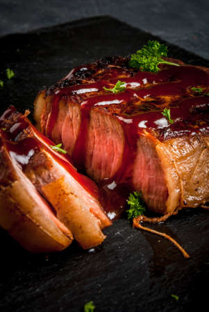 Fresh homemade fried beef steak with barbecue sauce and herbs, close viewの写真素材