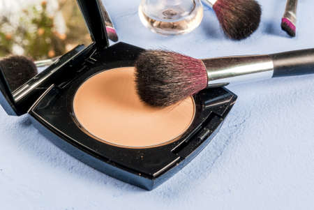 Set for makeup - brush, mascara, powder, copy space on light blue stone concrete tableの写真素材