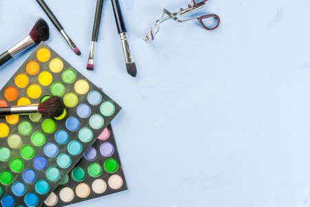 Set for makeup - brush, mascara, eye shadow, on a light blue stone concrete table top view copy spaceの写真素材