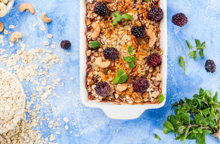 Freshly baked diet berry crumble with oatmeal with fresh berries blackberries decorated with mint...