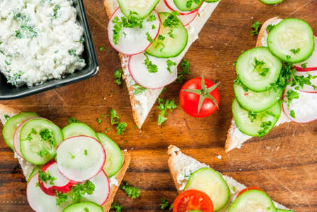 Vegan and healthy diet food: spring vitamin sandwiches with homemade curd cream with herbs, with...