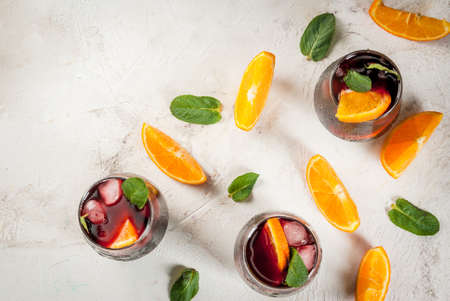 Traditional Spanish summer refreshing drink, cocktail, Tinto de verano. With wine, ice and pieces of fresh orange. On white stone  table, copy space top viewの写真素材