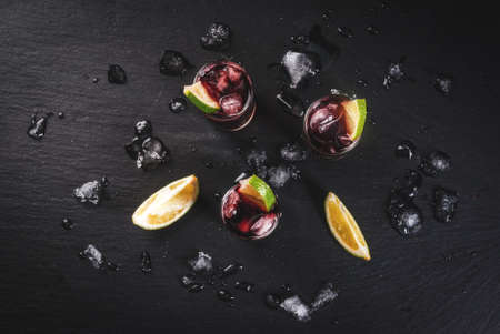 Traditional Spanish alcoholic drink, cocktail, Calimocho. With wine, cola, lime juice and ice. Decorated with pieces of lime. Copy space top viewの写真素材